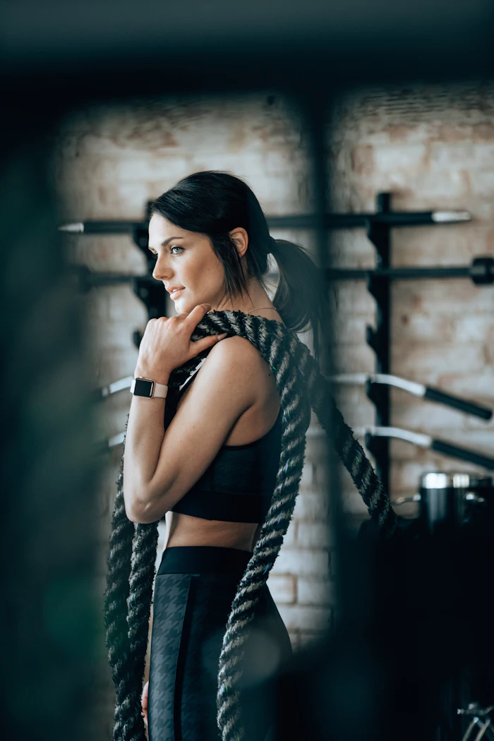Athlete working battle ropes during a conditioning circuit