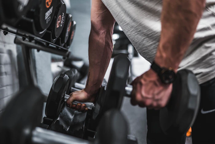 Hands gripping a loaded barbell